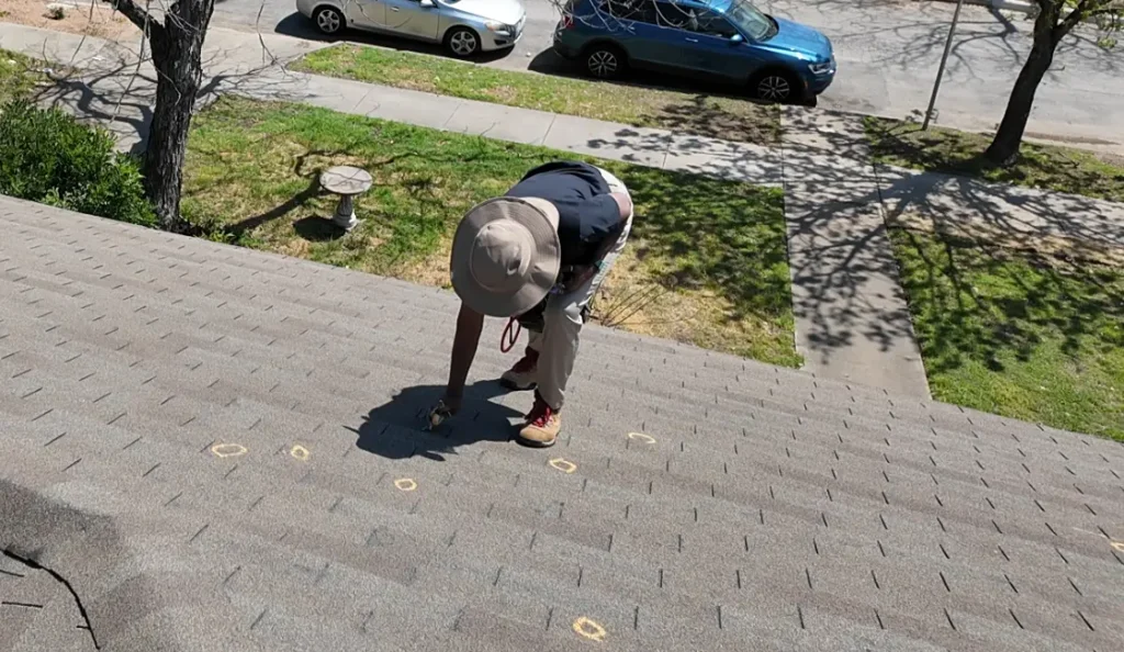 Insurance Adjuster Marking Roof For Hail Damage